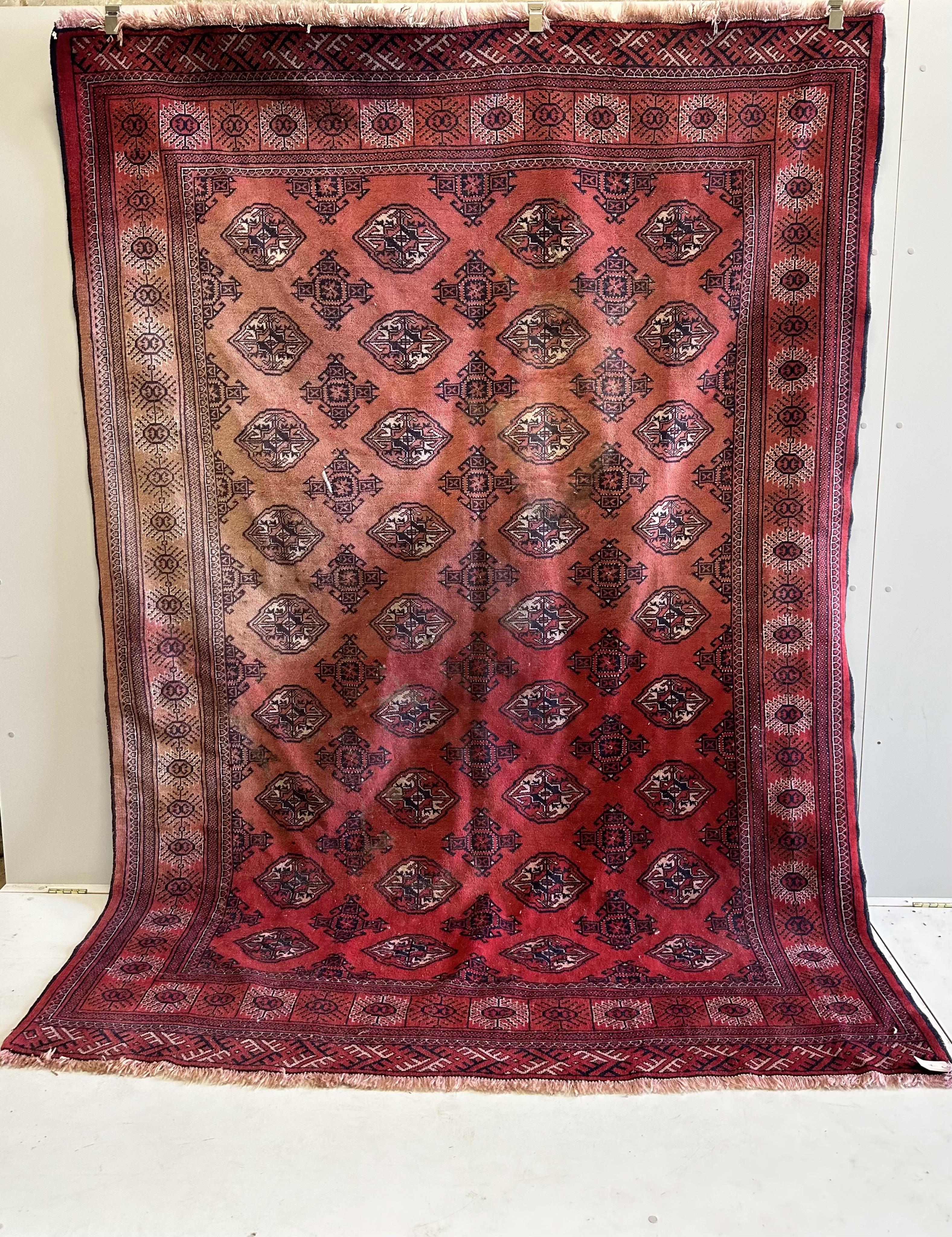 A Bokhara red ground carpet, 290 x 210cm. Condition - poor